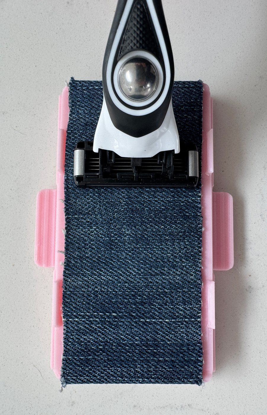 Razor cartridge resting on the Blush Pink Razor Maintainer, thumbnail